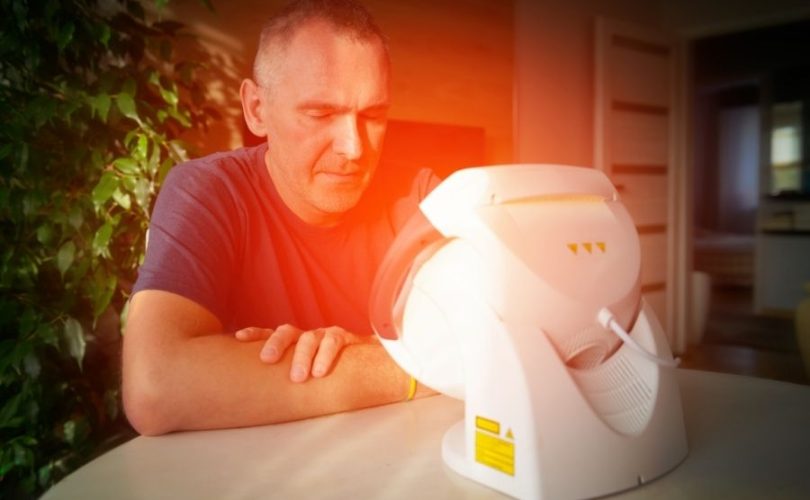 a man using light therapy lamp